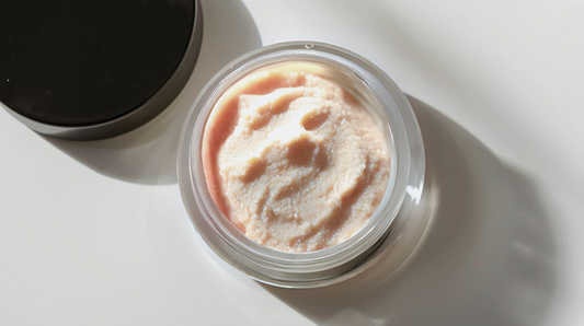 Jar of pink cream on a white surface